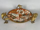 a plate with a bird on it and a bird on the plate