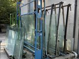 many pieces of glass sitting on the ground outside of a building