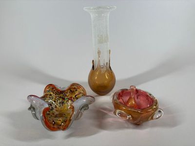 three glass vases sitting next to each other on a table