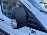 an image of a side view mirror of a white van