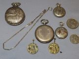 many different types of pocket watches on the table