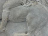 a statue of a woman riding a horse with a man on it