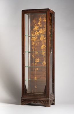 an antique wooden display case with a glass door and flowers