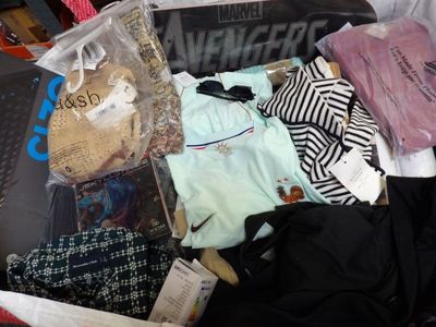 a suitcase full of clothes and a teddy bear in it
