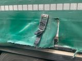 a green tarp covering the side of a truck