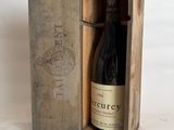 a wooden box with a bottle of wine inside of it