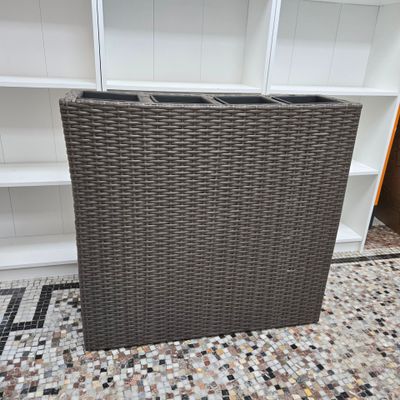 a brown wicker bar in a room with a tiled floor