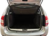 the back of a silver car with its trunk open on a white background