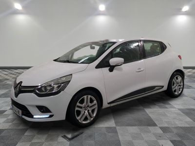 the white car is parked on a checkered tile floor