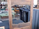 a wooden door with a mirror on it in a room