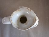 a white porcelain vase with a hole in the middle