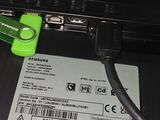 a black laptop with a green cable connected to it