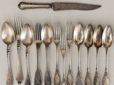 a lot of silver spoons and forks on the table