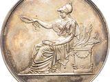 an image of a silver medal with a woman sitting on a bench