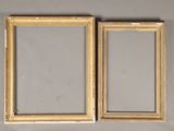 pair of antique gold picture frames on a grey background