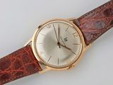 an image of a gold wrist watch with a brown leather strap