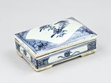 a small blue and white box on a white surface