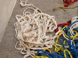 a pile of rope on the ground next to a box