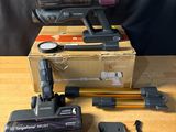 two vacuums are sitting on top of a table next to a box