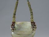 an image of a necklace made of glass and beads