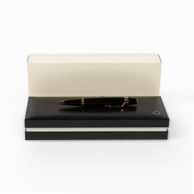 the pen is sitting on top of a black book
