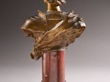 an antique bronze bust of a woman on a marble pedestal