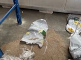 many bags of food on the floor in the room