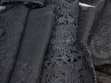 many different types of black lace on a table