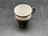 a close up of a coffee cup sitting on a table