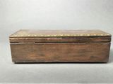 an old wooden box with gold trimming on the lid