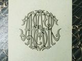 a drawing of a monogram on a piece of paper