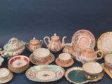 many different types of porcelain dishes and bowls on the table