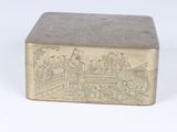 a metal box with a drawing on it on a white surface