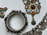 a lot of jewelry that is laying out on the table