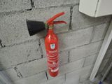 a fire extinguisor attached to the wall of a building