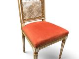 an image of a chair with a red seat and a gold frame