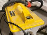 a yellow and black battery sitting on top of a desk