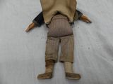 a doll that is laying down on a white sheet