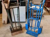 a blue hand truck with a box on top of it