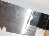 a large metal blade that is attached to a piece of wood
