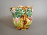 a ceramic owl with a basket of flowers on it ' s head