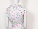 a white mannequin dress with colorful floral print on it