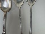 three spoons and two spoon spoons on a table