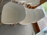 four white chairs that are sitting on the floor