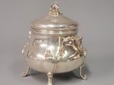 an antique silverplated teapot with handles and a lid