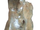 a statue of a man that is sitting on a rock