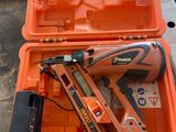 an orange tool box with a stapler and a nail gun in it