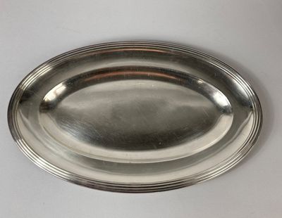 a silver plate on a table with a white background