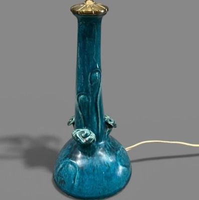 a blue lamp that is on a table next to a cord