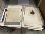 a lot of papers on a table with a picture of a man